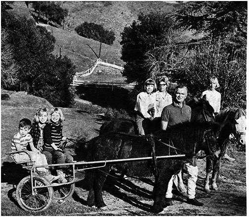 Buddy Ebsen and his family at his ranch. The pony hitched to the cart is Two-By Four with son Dustin and daughers Bonnie and Kiki. Buddy Ebsen is standing next to daughter Susannah and wife Nancy. Cathy is riding Orange Lover.