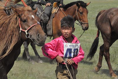 A young jockey cools off his horse after a 28km Naadam race that just happened to be running as the Gobi Gallop passed by. A young jockey cools off his horse after a 28km Naadam race that just happened to be running as the Gobi Gallop passed by.
