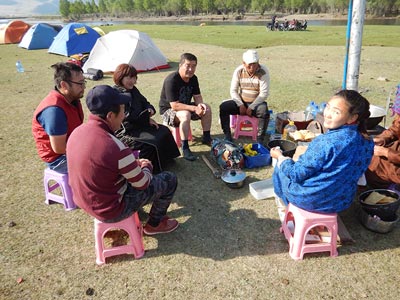 Camp by the River Tuul - The crew making a delicious breakfast of fry bread, fresh cream and jam! Seated facing away - Driver Baagii, to his left Dr. Sukhbaatar Garam, Sarantuya ( co owner of Horse Trek Mongolia and Camp Manager of the Gobi Gallop) Driver Khloyaa, guide Batsumber, Cook Tuya ( mostly missing) and assistant cook Ari. All the riders in the background. Camp by the River Tuul - The crew making a delicious breakfast of fry bread, fresh cream and jam! Seated facing away - Driver Baagii, to his left Dr. Sukhbaatar Garam, Sarantuya ( co owner of Horse Trek Mongolia and Camp Manager of the Gobi Gallop) Driver Khloyaa, guide Batsumber, Cook Tuya ( mostly missing) and assistant cook Ari. All the riders in the background.