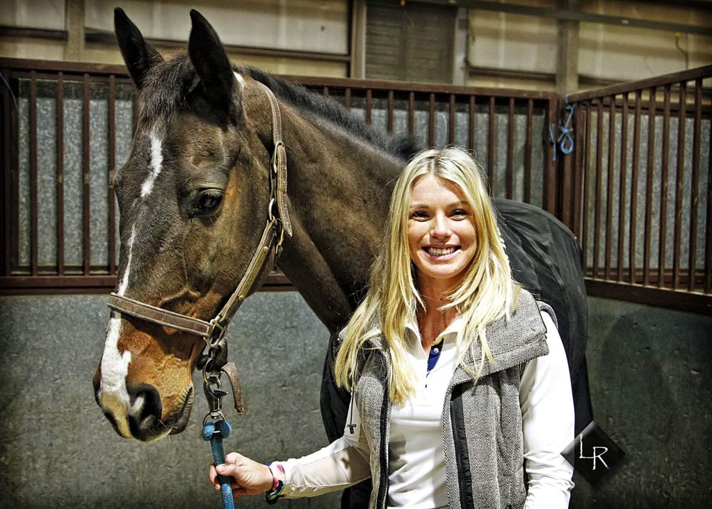 Photo by Lincoln Rogers | Twenty-three-year-old horse trainer and equestrian competitor Carly Ramsey from Honey Grove, Texas, not only competes in Hunter/Jumper and Grand Prix competitions, she also is hooked on ranch bronc riding. Ramsey has been wearing both hats at the 2020 National Western Stock Show in Denver. In her first time at the NWSS, she placed second and thrid in the two highest profile NWSS jumpng competitions aboard 16-year-old Irish Sport Horse Colin. Photo by Lincoln Rogers | Twenty-three-year-old horse trainer and equestrian competitor Carly Ramsey from Honey Grove, Texas, not only competes in Hunter/Jumper and Grand Prix competitions, she also is hooked on ranch bronc riding. Ramsey has been wearing both hats at the 2020 National Western Stock Show in Denver. In her first time at the NWSS, she placed second and thrid in the two highest profile NWSS jumpng competitions aboard 16-year-old Irish Sport Horse Colin.